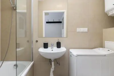 a bathroom with a sink and a shower at 1-Bedroom Apartment - Długa 65 in Kraków