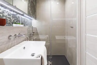 a bathroom with a white sink and a shower at Apartment in the Old Town - Karmelicka Street in Kraków