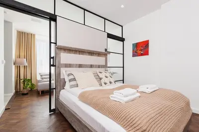a bedroom with a large bed with two towels on it at Apartment in the Old Town - Karmelicka Street in Kraków