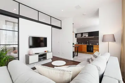 a living room with a white couch and a tv at Apartment in the Old Town - Karmelicka Street in Kraków