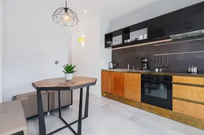 a kitchen with a table and a counter top at Apartment in the Old Town - Karmelicka Street in Kraków