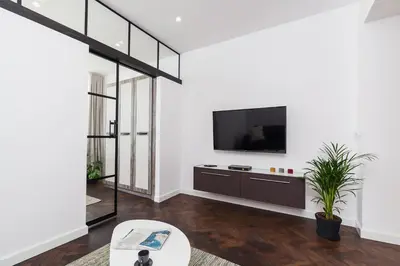 a living room with a flat screen tv on a wall at Karmelicka Street - Old Town in Kraków