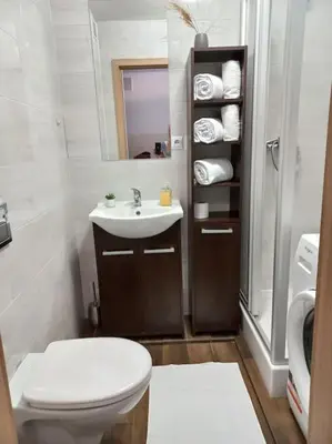 a bathroom with a toilet and a sink at Kawalerka w centrum in Wadowice