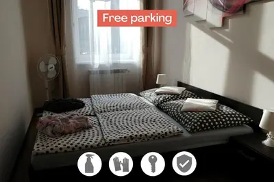 two beds in a room with the words free parking at Centrum Apartments in Kraków