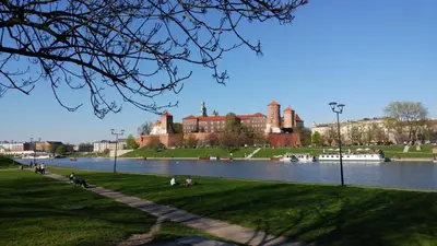 a view of a large building with a river in front at Centrum Apartments in Kraków