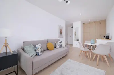 a living room with a couch and a table at Krowoderska Apartment with Balcony near City Center by Rent like home in Kraków