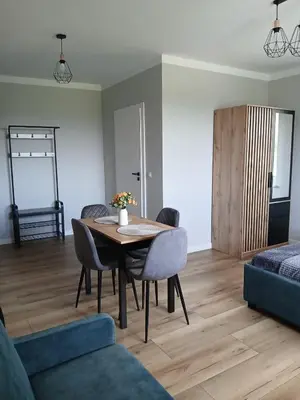 a living room with a table and chairs at Noclegi Sunny House in Witanowice