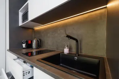 a kitchen with a sink and a counter top at Old Town Apartment with Balcony - Rajska 3 Street in Kraków