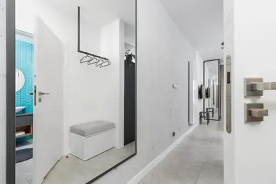 a bathroom with a toilet in a white wall at Old Town Apartment with Balcony - Rajska 3 Street in Kraków