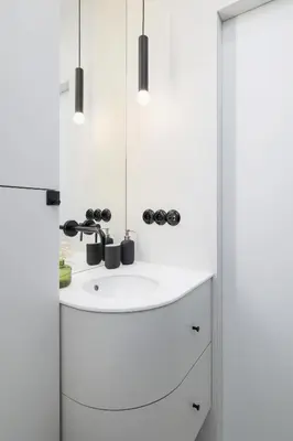 a white bathroom with a sink and a mirror at 1-Bedroom Apartment - Sławkowska 6a Street in Kraków