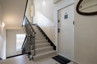 a stairway with a black and white staircase at 1-Bedroom Apartment - Sławkowska 6a Street in Kraków