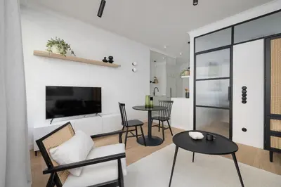 a living room with a tv and a table at 1-Bedroom Apartment - Sławkowska 6a Street in Kraków