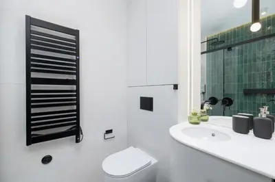 a white bathroom with a toilet and a sink at 1-Bedroom Apartment - Sławkowska 6a Street in Kraków