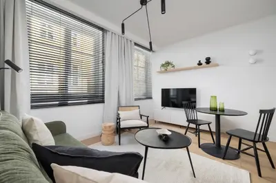 a living room with a couch and a table at 1-Bedroom Apartment - Sławkowska 6a Street in Kraków