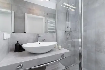 a bathroom with a white sink and a shower at Cozy studio with a balcony - Rajska 3 street in Kraków