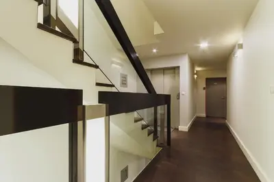 a staircase in a house with black railings at 3-Bedroom Apartment with balcony- Krowoderska in Kraków