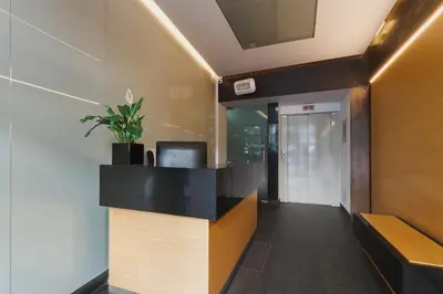 an office lobby with a desk with a potted plant at 3-Bedroom Apartment with balcony- Krowoderska in Kraków