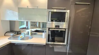 a kitchen with a sink and a microwave at Apartament Zielony Z Ogrodem in Kraków