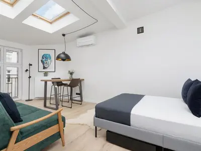 a bedroom with a bed and a table and a chair at Apartment in Kazimierz District - Starowislna 43 in Kraków