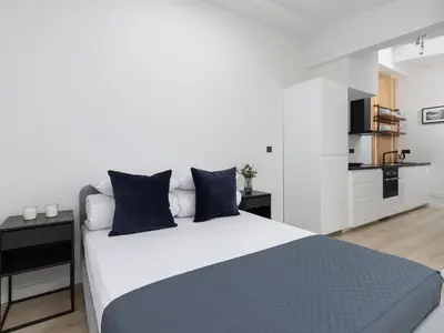 a bedroom with a large bed with blue pillows at Apartment in Kazimierz District - Starowislna 43 in Kraków