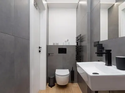 a bathroom with a white sink and a toilet at Apartment in Kazimierz District - Starowislna 43 in Kraków