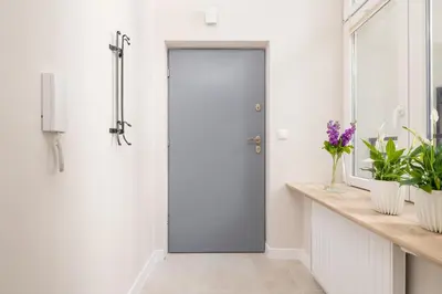 a pivot door in a bathroom with white walls at Studio for two - Kazimierz- 43 Starowiślna Street in Kraków