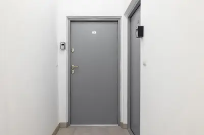 an empty corridor with a door in a building at Studio for two - Kazimierz- 43 Starowiślna Street in Kraków