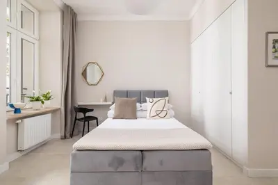 a bedroom with a large bed and a desk at Studio for two - Kazimierz- 43 Starowiślna Street in Kraków