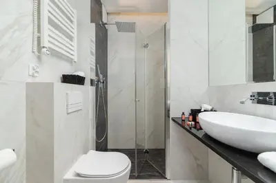a bathroom with a sink and a toilet and a shower at Modern Apartment Old Town Cracow by Noclegi Renters in Kraków