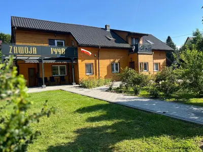 a building with a sign that reads akron true at Gnapówka in Zawoja
