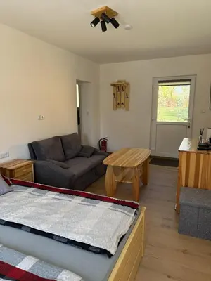 a living room with a couch and a table at Gnapówka in Zawoja