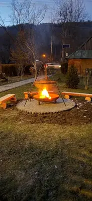 a fire pit in the middle of a field at Gnapówka in Zawoja