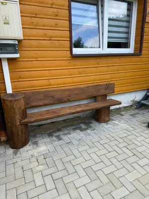a wooden bench sitting in front of a building at Gnapówka in Zawoja