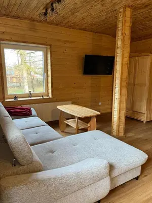 a living room with a couch and a table at Gnapówka in Zawoja
