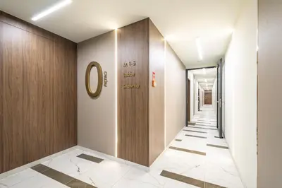 a corridor in a building with a hallway at Apollo Apartments Prochowa 6 in Kraków