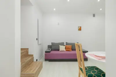 a living room with a couch and a table at Central Kraków Apartment by Noclegi Renters in Kraków