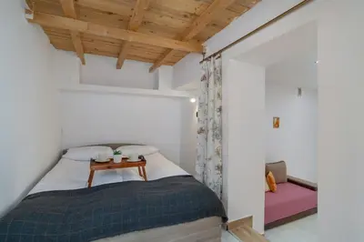 a bedroom with a bed with a table on it at Central Kraków Apartment by Noclegi Renters in Kraków