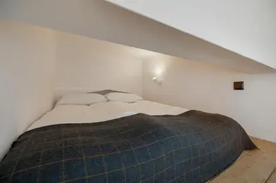 a bedroom with a bed with a plaid blanket at Central Kraków Apartment by Noclegi Renters in Kraków