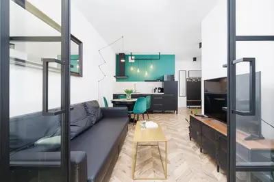 a living room with a couch and a table at Podgórze Golden Oriole Apartment Cracow by Renters Prestige in Kraków