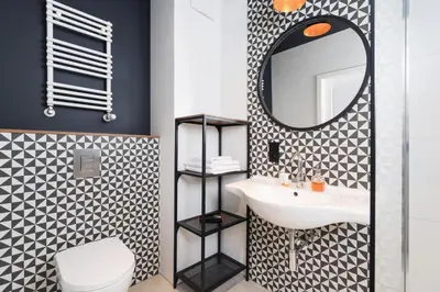 a bathroom with a sink and a mirror at Podgórze Golden Oriole Apartment Cracow by Renters Prestige in Kraków
