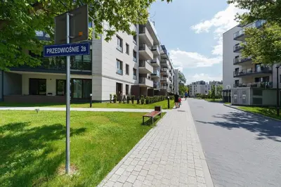 a street sign on a sidewalk next to a building at Podgórze Golden Oriole Apartment Cracow by Renters Prestige in Kraków