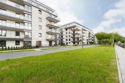an empty street in front of an apartment building at Podgórze Golden Oriole Apartment Cracow by Renters Prestige in Kraków