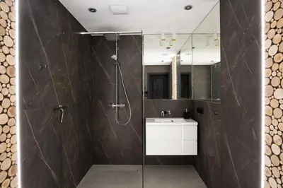 a bathroom with a shower and a sink and a mirror at House for 20 people with a private SPA and bar Koma House in Sidzina