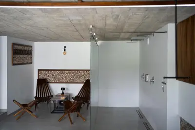 two chairs and a table in a room with white walls at House for 20 people with a private SPA and bar Koma House in Sidzina