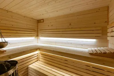 a wooden sauna with a window in it at House for 20 people with a private SPA and bar Koma House in Sidzina