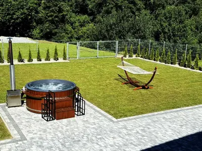a hammock in the middle of a soccer field at House for 20 people with a private SPA and bar Koma House in Sidzina