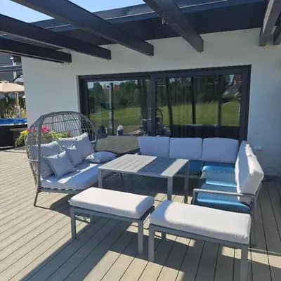 a patio with blue and white furniture and a table at TinyApartament in Skawa