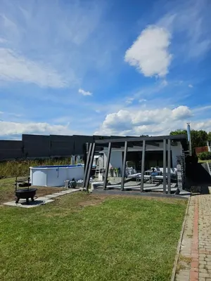 a building with a bench in the grass at TinyApartament in Skawa