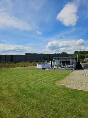 a building with a grass field in front of it at TinyApartament in Skawa
