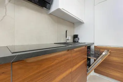 a kitchen with a sink and a counter top at Zbożowa 2A Apartments Nowy Kleparz Cracow by Noclegi Renters in Kraków
